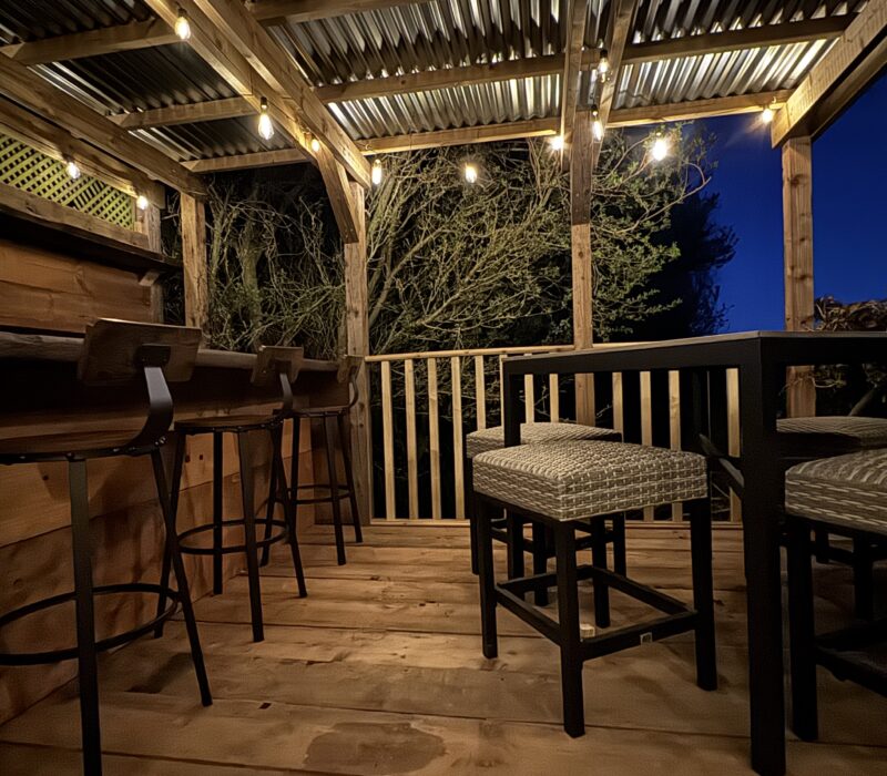 Solar powered string lights illuminate the bar.
